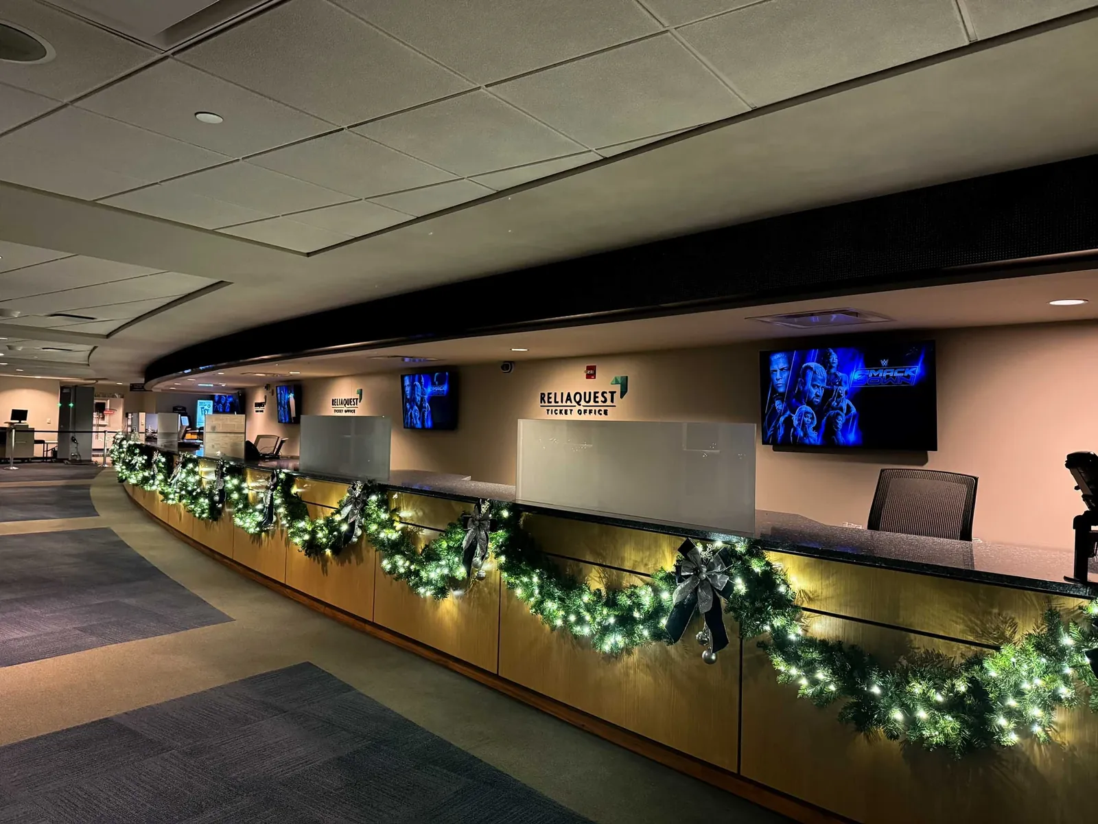 Lit garland with navy and silver bows along the ReliaQuest Ticket Office counter