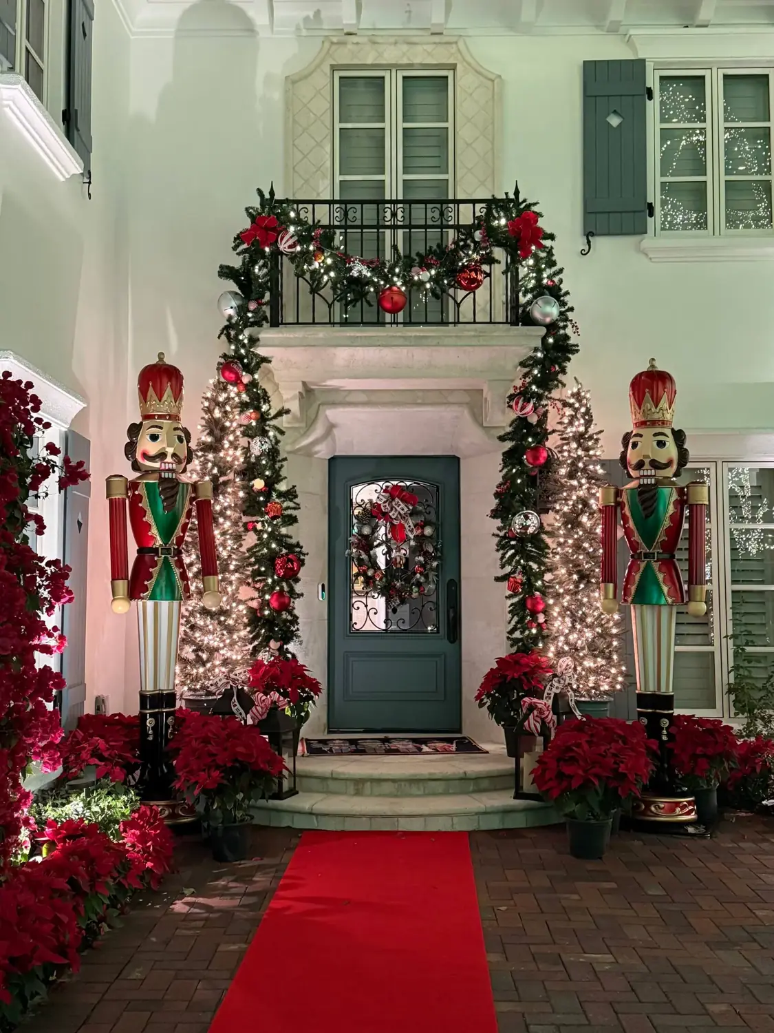 Christmas entrance with nutcrackers, garland, wreaths and a red carpet on a Tampa home